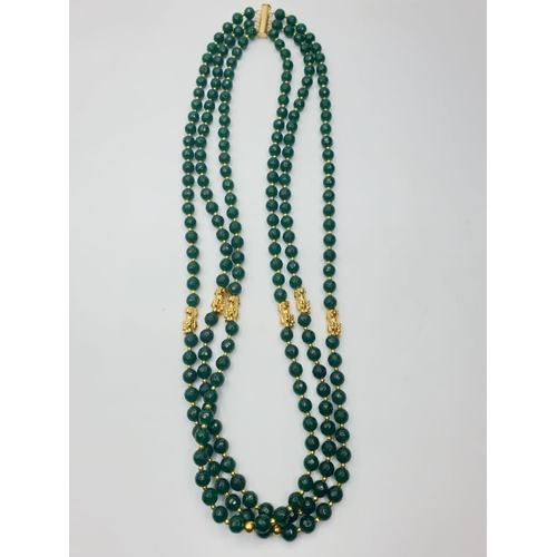 74 - A three row, Chinese necklace, faceted, dark green, jade with gold filled PIXIUs. Length: 61 – 67cm.... 