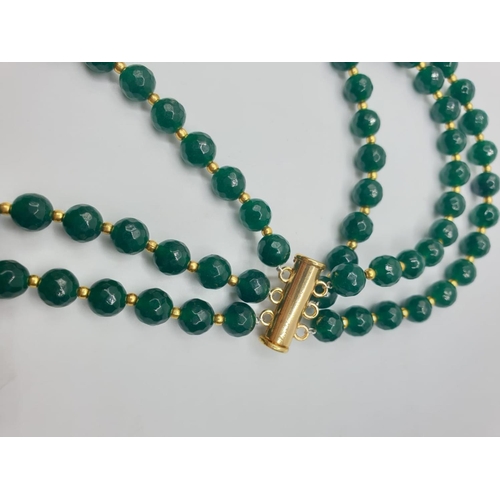 74 - A three row, Chinese necklace, faceted, dark green, jade with gold filled PIXIUs. Length: 61 – 67cm.... 