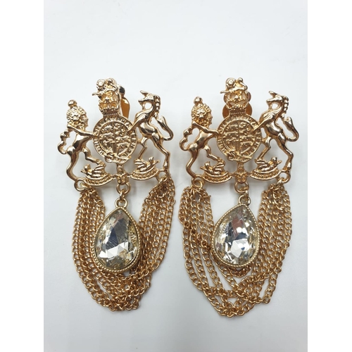 80 - A statement pair of earrings with the British Royal Coat of Arms and a trilogy of rings with clear s... 