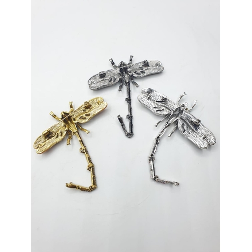 92 - Three large dragonfly brooches in a wooden box. Enamel applied by hand on various metals with imitat... 