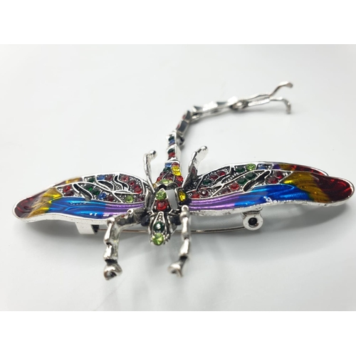 92 - Three large dragonfly brooches in a wooden box. Enamel applied by hand on various metals with imitat... 