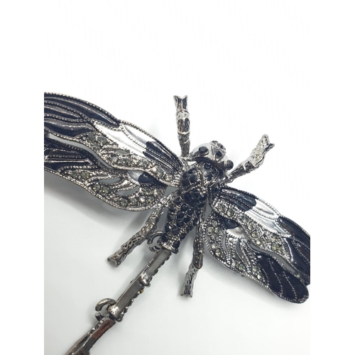 92 - Three large dragonfly brooches in a wooden box. Enamel applied by hand on various metals with imitat... 