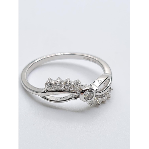 299 - 18ct white gold diamond fancy ring weight 2.3g with 0.25ct diamonds approx size N