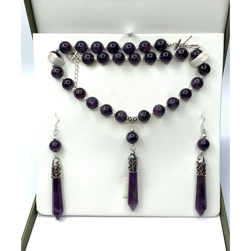 527 - A boxed  amethyst necklace and earrings set. White metal clasp stamped “925”. Necklace length (max):... 