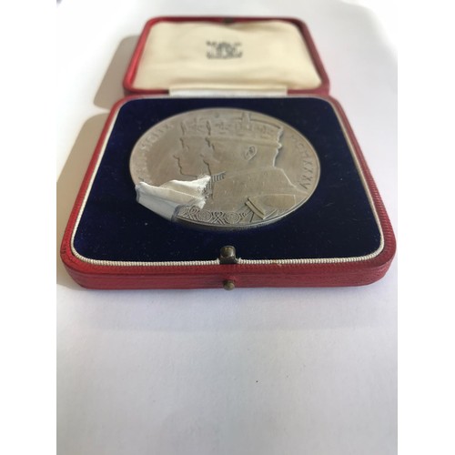 521 - A cased George and Mary Jubilee medal in fine condition.