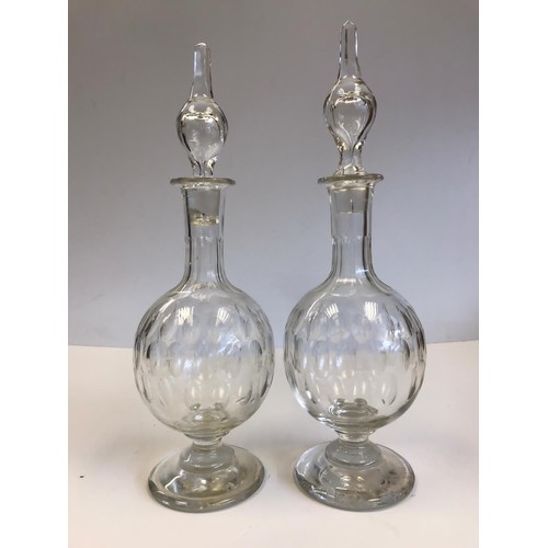 524 - A pair of Georgian hand blown decanters with their original stoppers. One stopper insert is damaged ... 