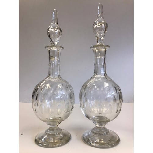 524 - A pair of Georgian hand blown decanters with their original stoppers. One stopper insert is damaged ... 