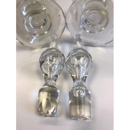 524 - A pair of Georgian hand blown decanters with their original stoppers. One stopper insert is damaged ... 