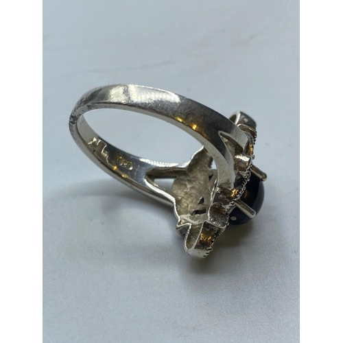 190 - Silver RING having marcasite work to top with black onyx cabochon sit in a four claw raised mount.  ... 