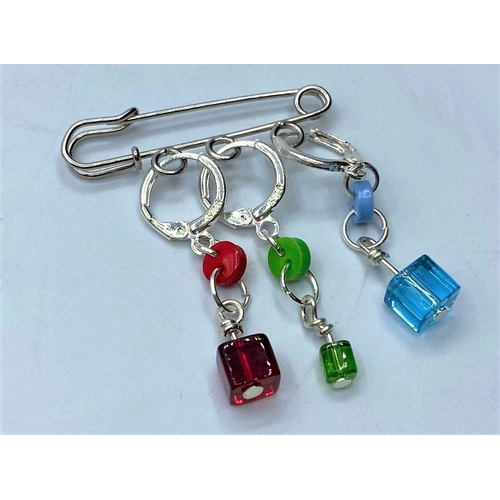 293 - Three silver drop earrings having silver hoops and coloured stones presented on a large pin. 925 sil... 