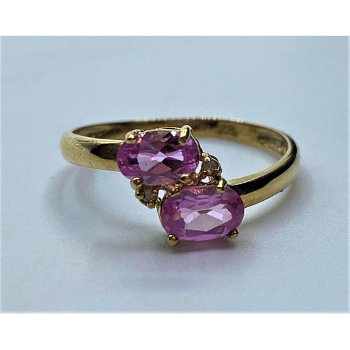 85 - 9ct gold pink topaz and diamond RING.
having twin faceted oval pink topaz to mount with two small di... 