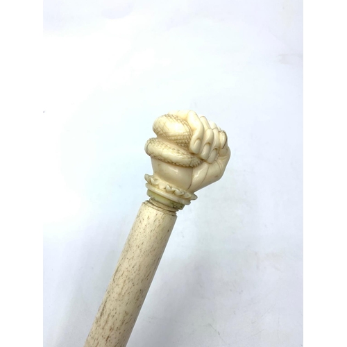 120 - 19th century whale bone walking stick with carved hand holding serpent, 83cm long approx