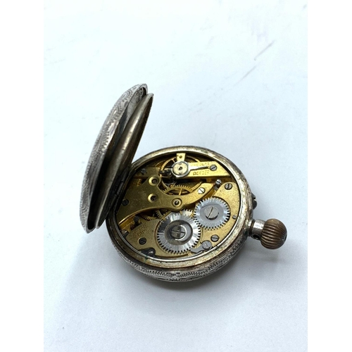 351 - Antique silver ladies open face pocket watch, having chased scroll engraving, top winding with ename... 