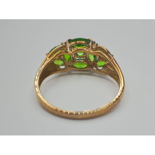 198 - 9ct gold ring having large green diopside coloured stones in cluster setting.
Full UK hallmark for 9... 