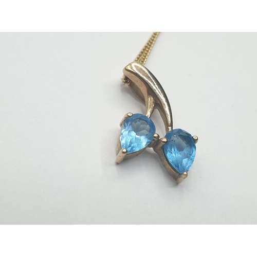 206 - 9CT Y/G BLUE TOPAZ SET PENDANT ON CHAIN, WEIGHT 1.8G AND 47CM LONG APPROX