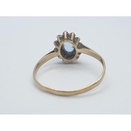 237 - 9CT Y/G BLUE AND WHITE STONE DRESS CLUSTER RING , WEIGHT 1.4G AND SIZE N1/2