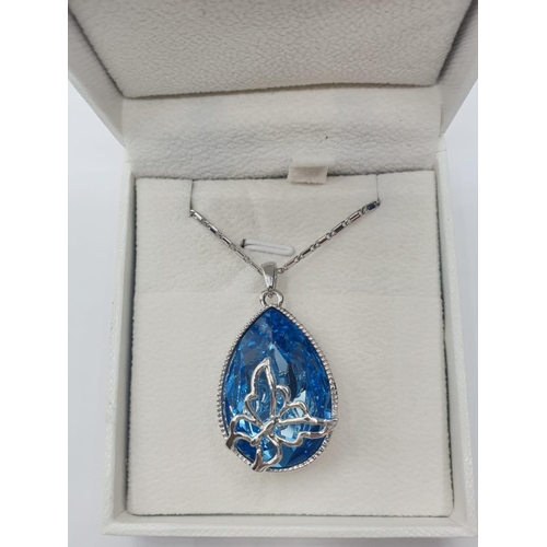 289 - Swarovski teardrop butterfly PENDANT.  Having a blue crystal pear shaped stone with beaded border an... 