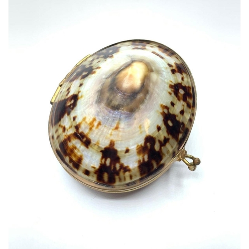 137 - A very unusual trinket box consisting of two polished limpets – with radiating mother of pearl – rev... 