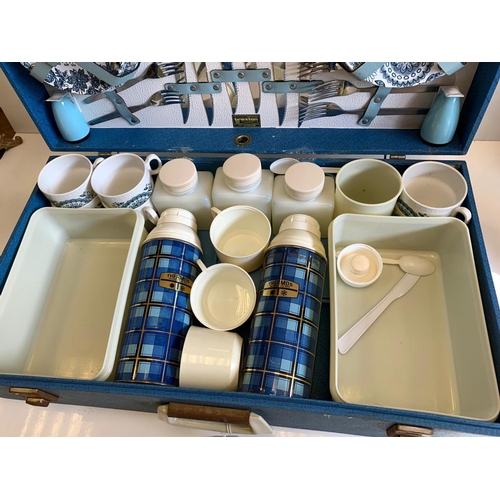 371 - A 1960's picnic set to include 2 thermos flasks, air tight containers, cutlery and crockery