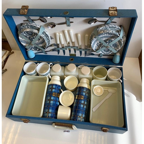 371 - A 1960's picnic set to include 2 thermos flasks, air tight containers, cutlery and crockery