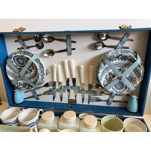 371 - A 1960's picnic set to include 2 thermos flasks, air tight containers, cutlery and crockery