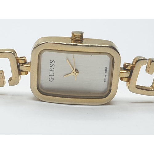 324 - Ladies Guess wristwatch. Swiss made having rectangular face and quartz movement. Full working order.... 