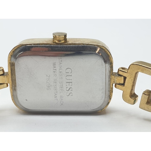 324 - Ladies Guess wristwatch. Swiss made having rectangular face and quartz movement. Full working order.... 