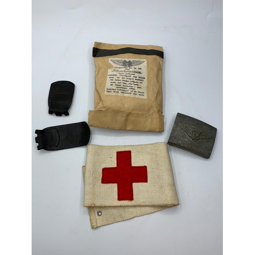 215 - WW2 German Luftshutz (air raid police ) buckle, armband and first aid dressing, as found in an old c... 