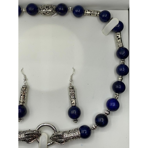 146 - A lapis lazuli and Tibetan Style silver necklace and earrings set in a   
presentation box. Necklace... 