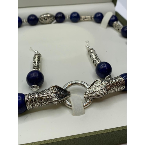 146 - A lapis lazuli and Tibetan Style silver necklace and earrings set in a   
presentation box. Necklace... 