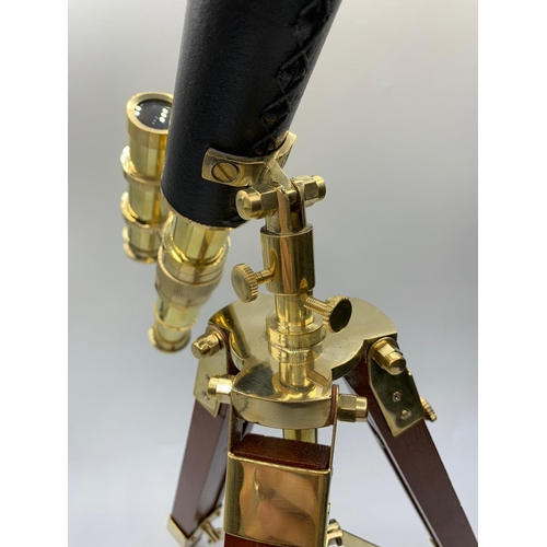 28 - A highly ornamental, modern, brass, replica of an Edwardian telescope,
on a mahogany and brass adjus... 