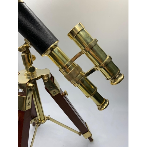 28 - A highly ornamental, modern, brass, replica of an Edwardian telescope,
on a mahogany and brass adjus... 