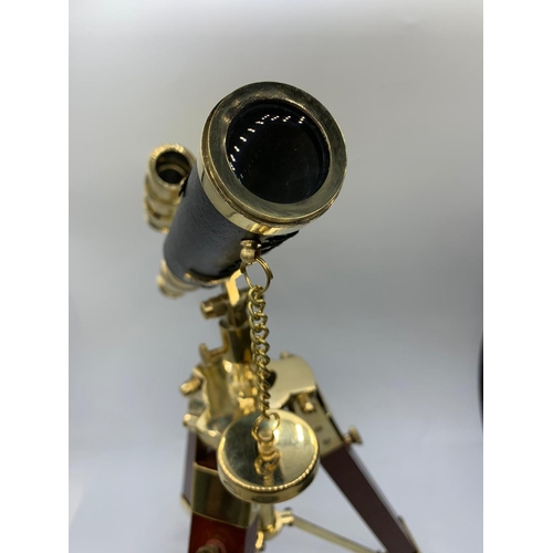 28 - A highly ornamental, modern, brass, replica of an Edwardian telescope,
on a mahogany and brass adjus... 