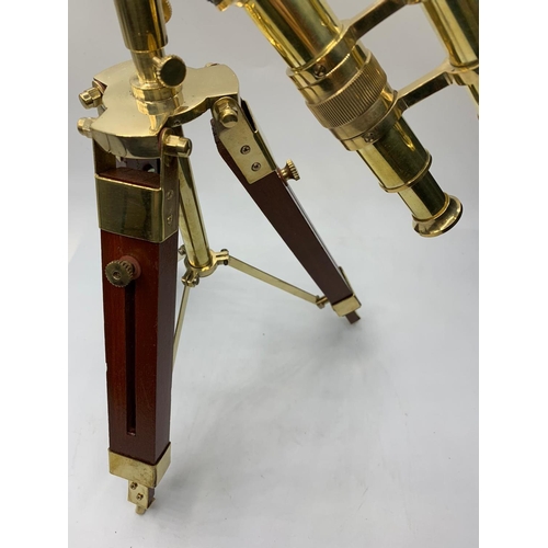 28 - A highly ornamental, modern, brass, replica of an Edwardian telescope,
on a mahogany and brass adjus... 