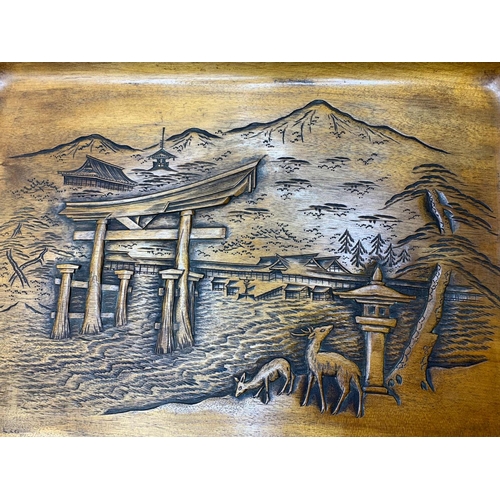 38 - A wooden tray with relief carving of Itsukushima Shinto Shrine in Japan.            
It depicts the ... 