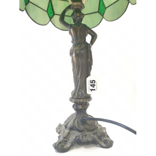 145 - Tiffany style LAMP. Lady  holding torch stem. Metal base.