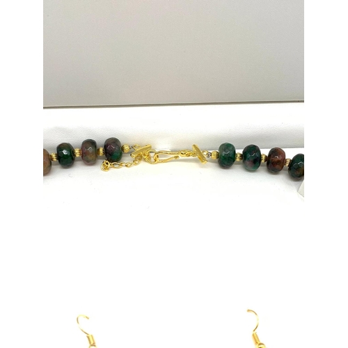 140 - A Chinese multicoloured and multifaceted jade beads with gold filled spacer
beads and pixiu dogs nec... 