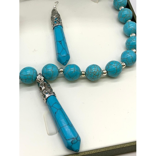 147 - A Tibetan turquoise style necklace and earrings set in a presentation box.
Necklace clasp in the sha... 