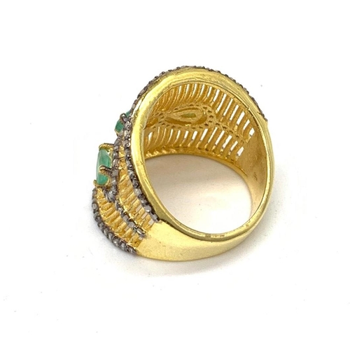 18 - A gold and silver ring with 3 Colombian emeralds and over 150 diamonds
(tested) on parallel, curved ... 