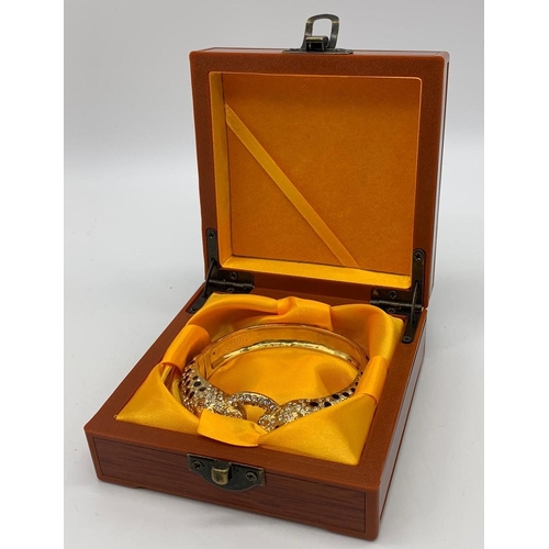 56 - A large silver (stamped 925) and gold plated bracelet in the Cartier style
Weight: 82g. In a present... 