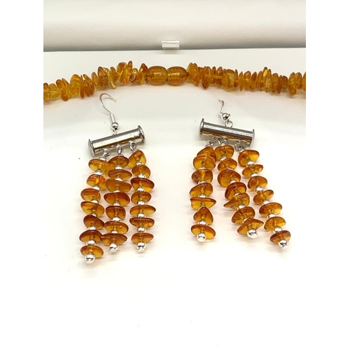 63 - A Baltic amber six row braided necklace and a pair of earrings set in a
presentation box. Necklace l... 