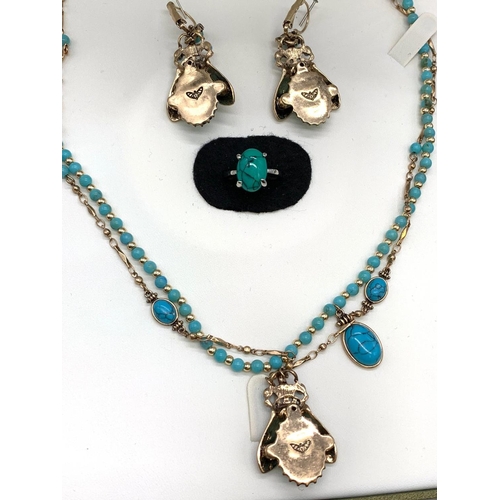 70 - An Egyptian revival set consisting of a double necklace, a matching pair
of earrings and a ring. In ... 