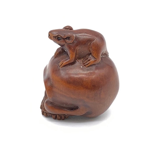 84 - A finely carved boxwood netsuke representing a human skull with a rat
Although the skull represents ... 