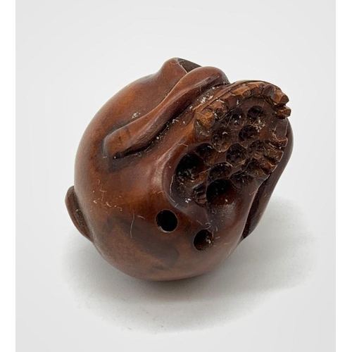 84 - A finely carved boxwood netsuke representing a human skull with a rat
Although the skull represents ... 