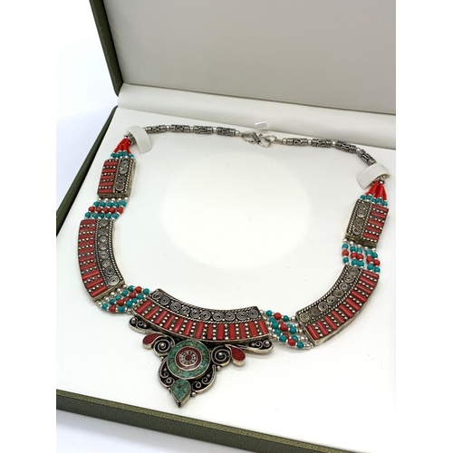 91 - A Tibetan silver with red coral and turquoise ethnic necklace presented in
a box. Necklace length: 4... 