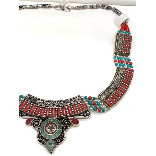 91 - A Tibetan silver with red coral and turquoise ethnic necklace presented in
a box. Necklace length: 4... 