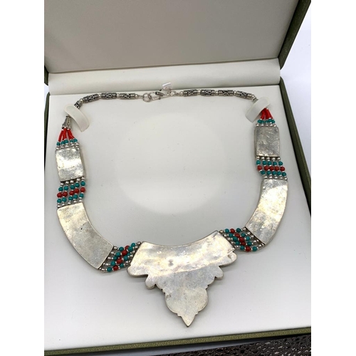 91 - A Tibetan silver with red coral and turquoise ethnic necklace presented in
a box. Necklace length: 4... 