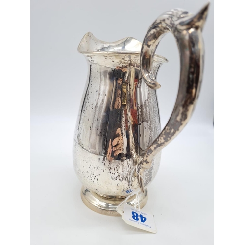 48 - A Silver Water Jug with Ornate Handle. 20cm Height. Weight: 628 grams