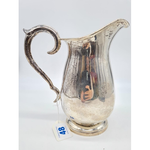 48 - A Silver Water Jug with Ornate Handle. 20cm Height. Weight: 628 grams