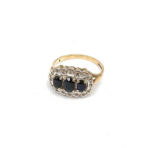 330 - 9ct Gold Ring with 3 centre Sapphires surround by small diamond. 3g size N